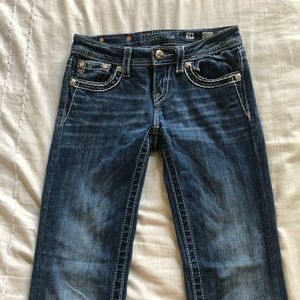 Miss Me Jeans with wings on the back pockets.